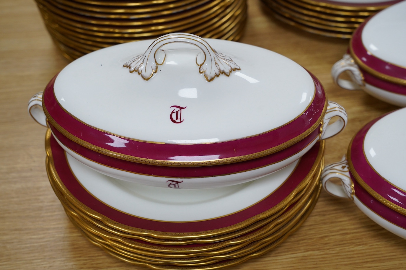 An extensive T. Goode & Co. Wedgwood red and gilt bordered dinner service, monogrammed 